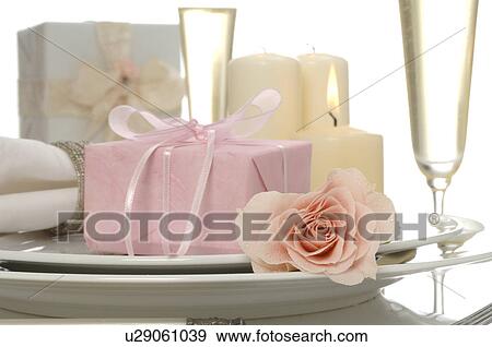 Arrangement with a pink rose, candles, gifts and sparkling wine View Large Photo Image Stock Photo - Arrangement with a pink rose, candles, gifts and sparkling wine. Fotosearch