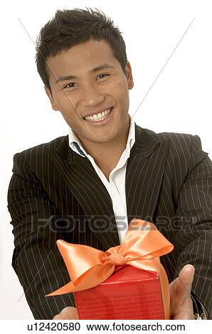 Stock Image - Asian man with a gift. Fotosearch