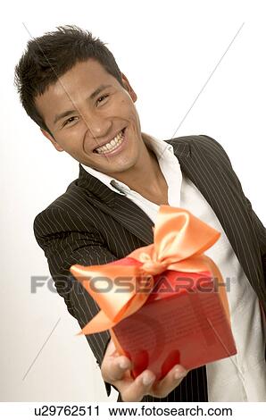 Stock Image - Asian man with a gift. Fotosearch
