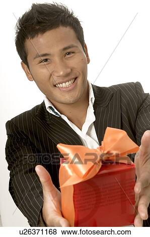 Stock Photo - Asian man with a gift. Fotosearch