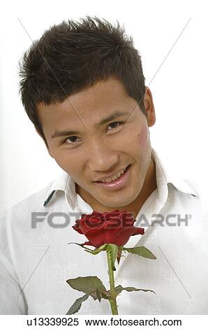 Asian man with a red rose View Large Photo Image Stock Photography - Asian man with a red rose. Fotosearch