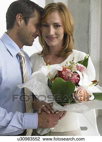 Stock Image - Couple with a bouquet. Fotosearch
