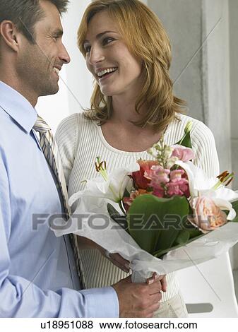 Stock Photo - Couple with a bouquet. Fotosearch