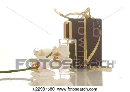 Gift and a small perfume bottle an orchids View Large Photo Image Stock Image - Gift and a small perfume bottle an orchids. Fotosearch