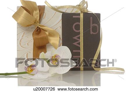 Stock Photograph - Gifts and orchid blossoms. Fotosearch