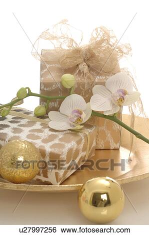 Gifts on a plate decorated with christmas balls and orichd blossoms View Large Photo Image Stock Photograph - Gifts on a plate decorated with christmas balls and orichd blossoms. Fotosearch
