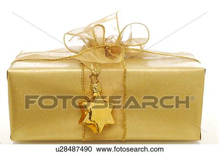 Stock Image - Gold gift with a pendants. Fotosearch