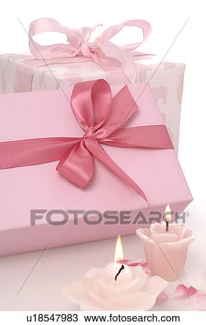 Stock Image - Pink gifts and pink candles. Fotosearch