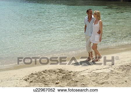Stock Image - Couple on the beach. Fotosearch