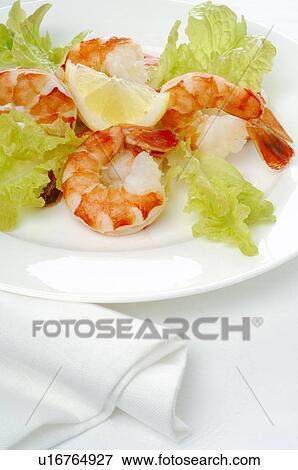 Stock Photo - Dish of shrimps, lemon and salad. Fotosearch