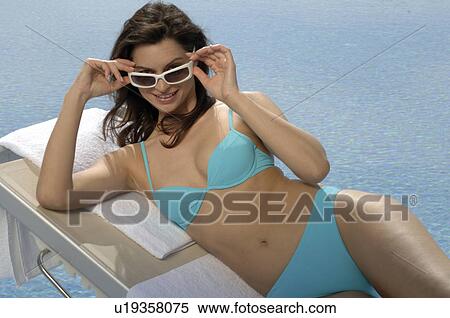 Woman on the sunlounger with sunglasses View Large Photo Image Stock Photography - Woman on the sunlounger with sunglasses. Fotosearch