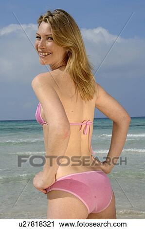 Stock Image - Woman with a bikini on the beach. Fotosearch