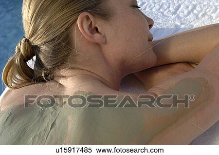Stock Photography - Woman with a body mask on her back. Fotosearch