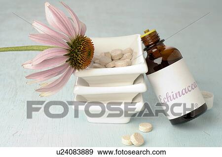 Stock Photo - Echinacea drops and pills in a small bowl. Fotosearch