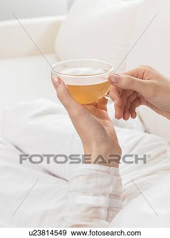 Stock Photo - Tea glass held by two hands. Fotosearch