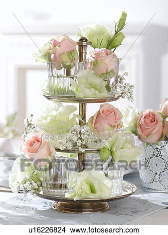 Picture - Etagere with rose blossoms in glasses. Fotosearch