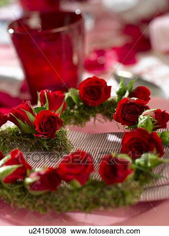 Stock Photo - Heart shape wreath with red rose blossoms. Fotosearch