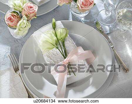Picture - Place setting decorated with eustoma and a white napkin. Fotosearch