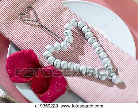 Place setting with a heart made of wire and white stones View Large Photo Image Stock Photo - Place setting with a heart made of wire and white stones. Fotosearch