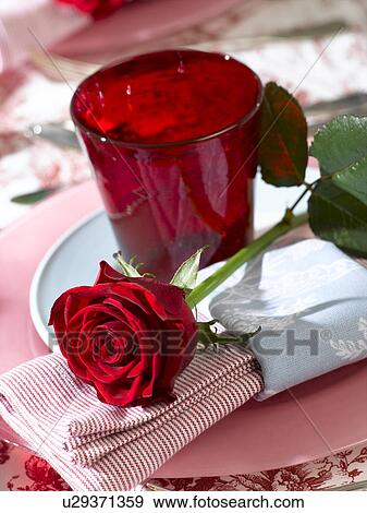 Place setting with a red glass and a red rose View Large Photo Image Stock Photo - Place setting with a red glass and a red rose. Fotosearch