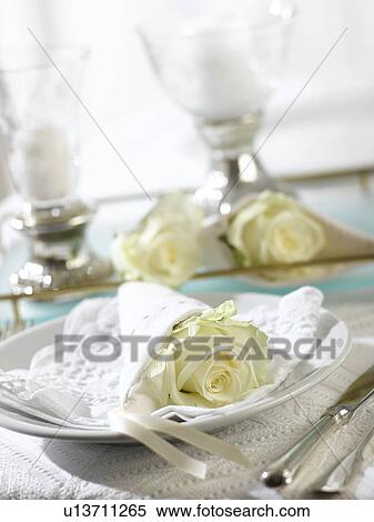Place setting with a white rose wrapped in a napkin View Large Photo Image Stock Photography - Place setting with a white rose wrapped in a napkin. Fotosearch