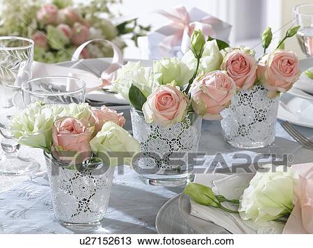Stock Image - Three little bouquets of eustoma and roses. Fotosearch