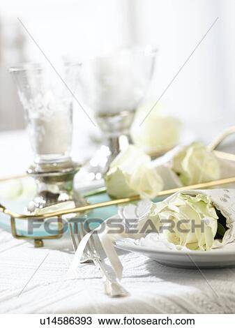 Two table lanterns and a place setting with a white rose wrapped in a napkin View Large Photo Image Stock Image - Two table lanterns and a place setting with a white rose wrapped in a napkin. Fotosearch