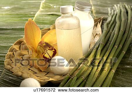 Stock Image - Facial toner with cotton and orchid blossom. Fotosearch