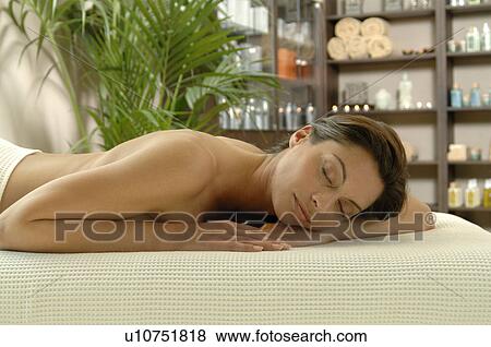 Stock Photo - woman relaxing on her stomach - her eyes closed. Fotosearch