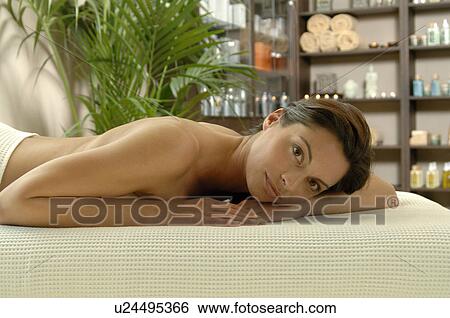 Stock Photograph - woman relaxing on her stomach. Fotosearch