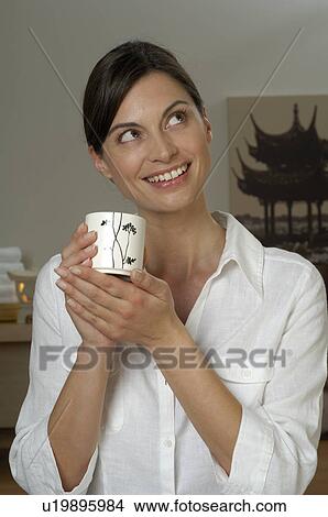 Young woman with a tea mug View Large Photo Image Picture - Young woman with a tea mug. Fotosearch