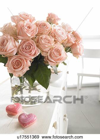 Stock Photo - Pink bouquet of roses and heartshape candles. Fotosearch
