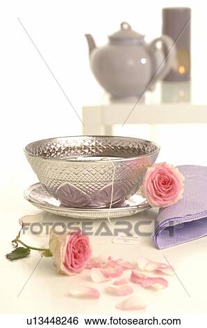 Stock Photograph - Pink roses and a silver teacup. Fotosearch