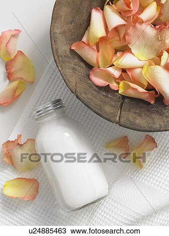 Rose petals in a wooden bowl and a cosmetic bottle View Large Photo Image Stock Image - Rose petals in a wooden bowl and a cosmetic bottle. Fotosearch