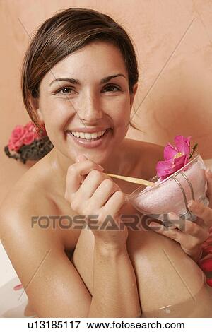 Stock Photo - Woman with a bowl with bath salts and petals. Fotosearch
