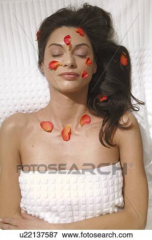 Stock Photo - Woman with petals on her skin. Fotosearch