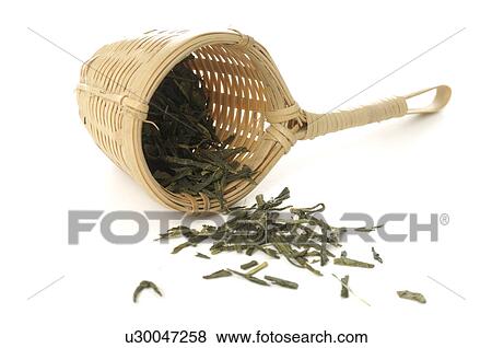 Stock Photo - Bamboo tea strainer with green tea. Fotosearch
