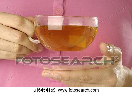 Stock Photo - Cup of tea in a hand. Fotosearch