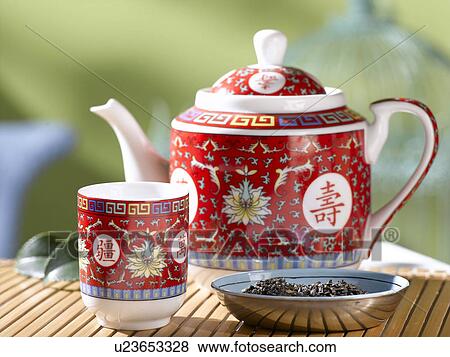 Stock Photo - Geen tea in a red asian teapot and teacup. Fotosearch