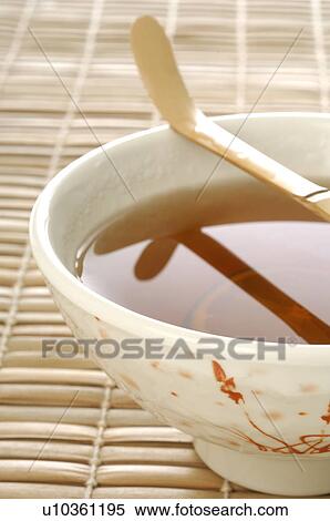 Stock Photography - Tea bowl with a bamboo spoon. Fotosearch