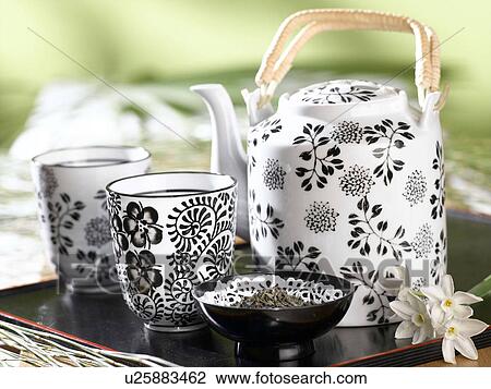 Stock Image - Tea set with a black and white flower pattern. Fotosearch