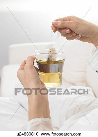 Teabag is being taken from tea glass View Large Photo Image Stock Image - Teabag is being taken from tea glass. Fotosearch
