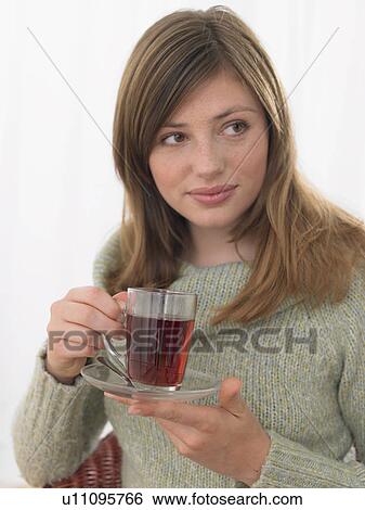Woman is drinking a cup of tea View Large Photo Image Stock Photograph - Woman is drinking a cup of tea. Fotosearch