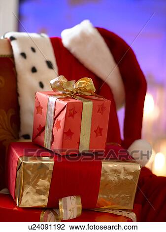 Stock Image - Christmas gifts on a chair. Fotosearch