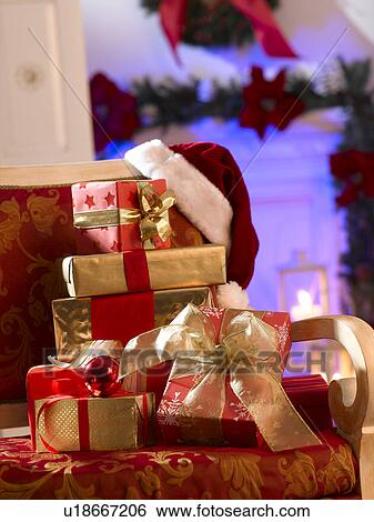 Stock Photograph - Christmas gifts on a chair. Fotosearch