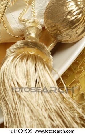 Stock Photo - Golden place setting with a tassel. Fotosearch