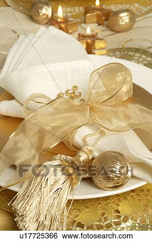 Stock Photograph - Golden place setting with a tassel. Fotosearch
