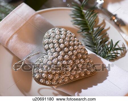 Napkin and a heart hanger embroided with pearls View Large Photo Image Stock Image - Napkin and a heart hanger embroided with pearls. Fotosearch