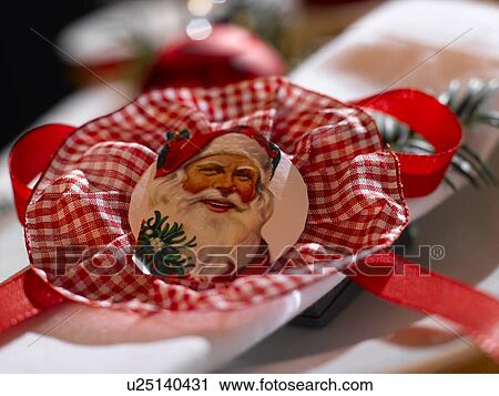 Stock Image - Napkin decorated with a Santa Claus wafer. Fotosearch