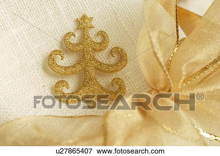 Napkin with a Christmas tree pattern tied with a golden ribbon View Large Photo Image Stock Photo - Napkin with a Christmas tree pattern tied with a golden ribbon. Fotosearch